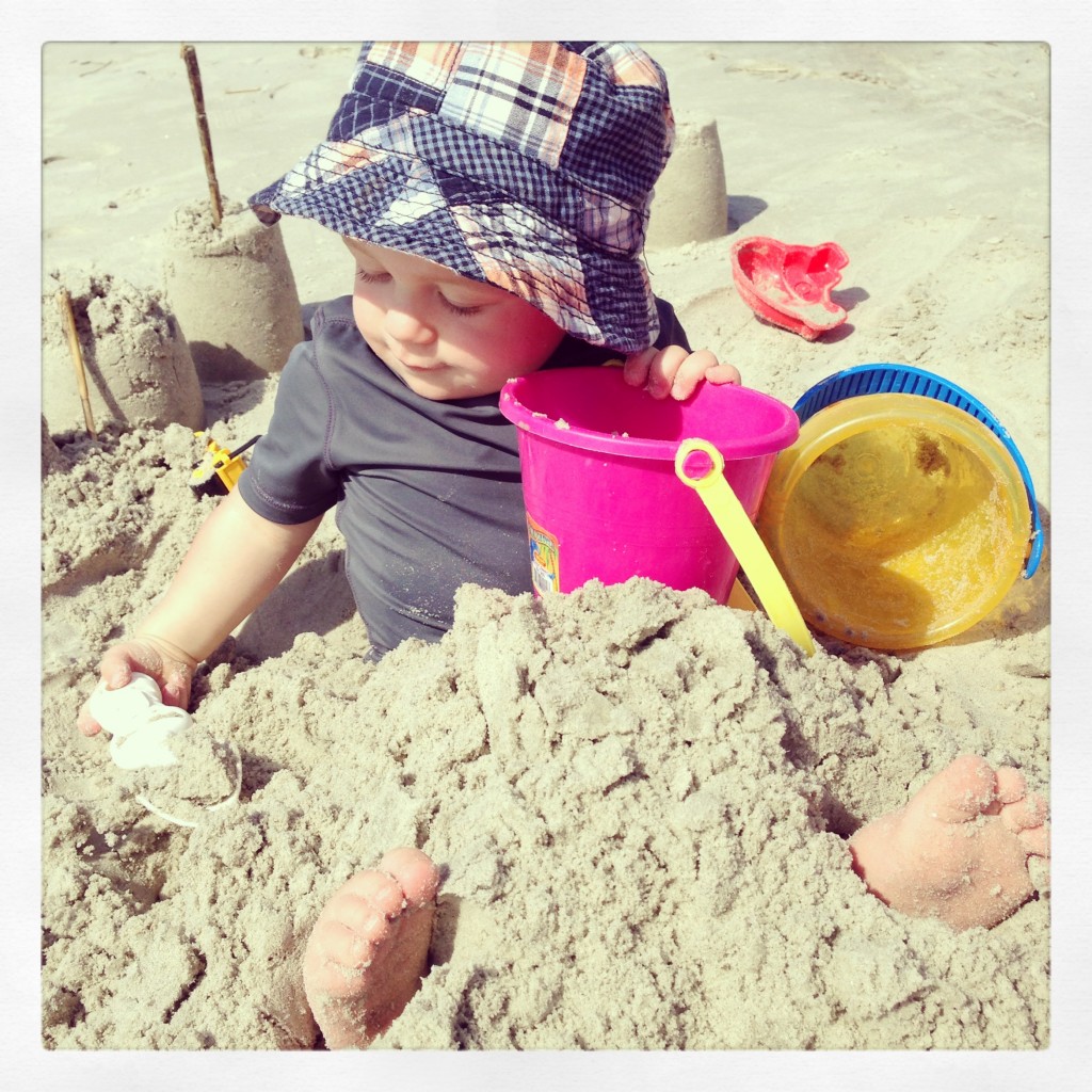 toddler buried in sand