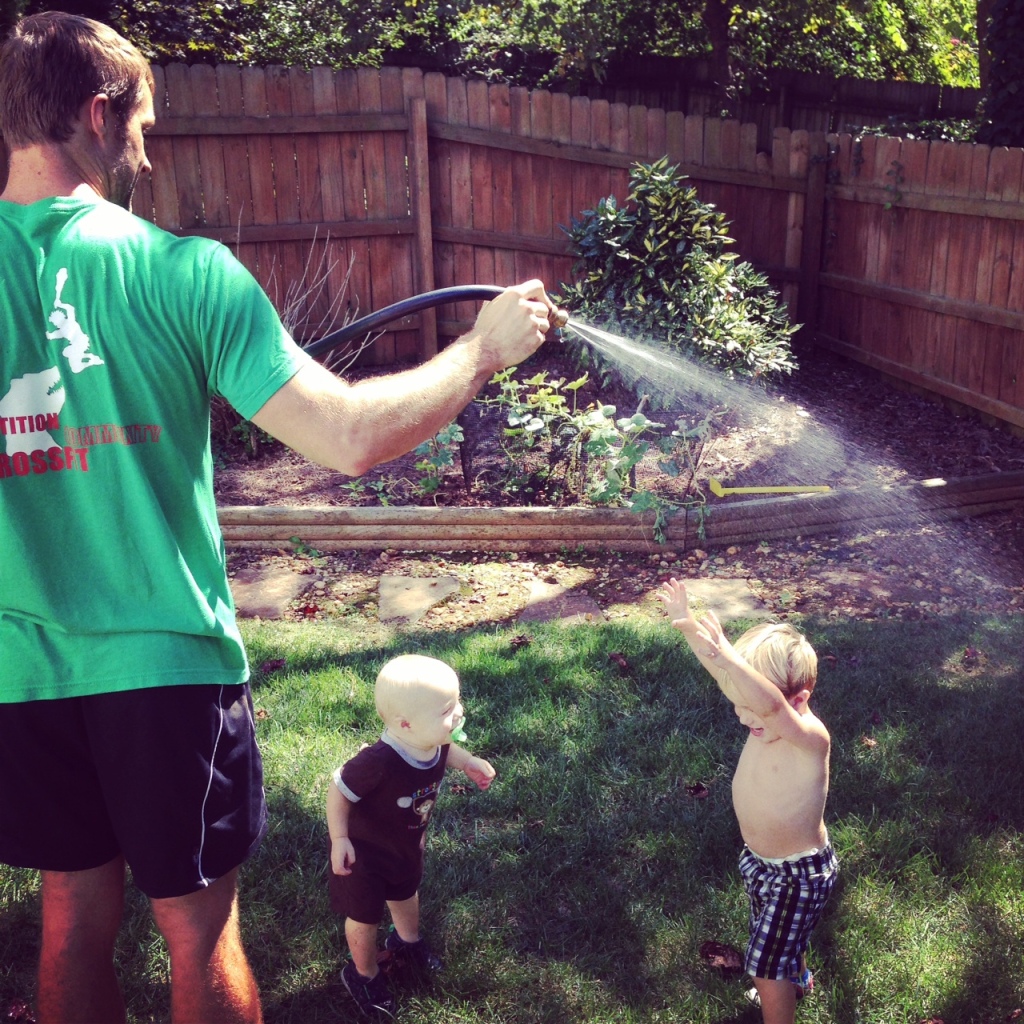 three boys water hose