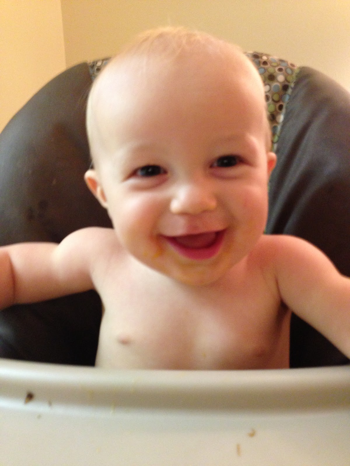 Shirtless baby in highchair